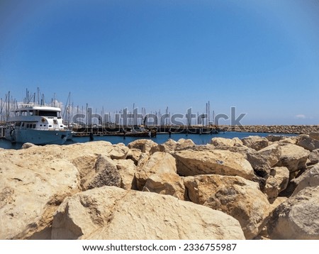 Ships on the dock with rocks in the foreground. High quality photo
