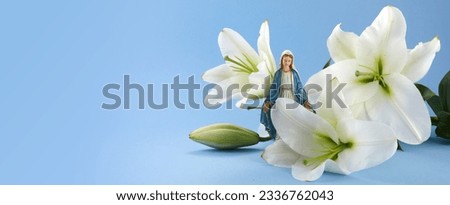 Assumption of Mary day. Virgin Mary figurine with lily flowers. Royalty-Free Stock Photo #2336762043