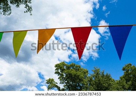 Triangles of flags on a blue sky background.
