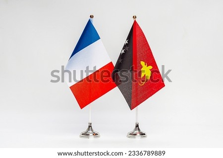 National flags of France and Papua New Guinea on a light background. Flags.