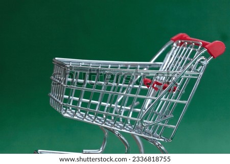 shopping trolley on the green background