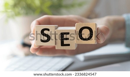 SEO Words on Wooden Block in hand, stock photo