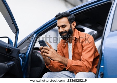 Car Navigation Application. Happy Middle Eastern Man Using Phone Sitting In Auto With Opened Door, Searching Best Way Via Mobile Gps Navigator App, Posing With Gadget In Luxury Automobile
