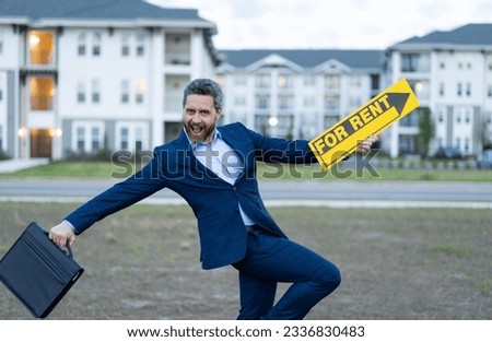 photo of cheerful renter adviser man with for rent sign outdoor