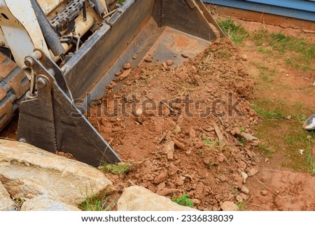 Mini bulldozer proficiency in earthmoving operations facilitates completion of landscaping works Royalty-Free Stock Photo #2336838039
