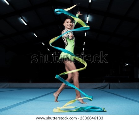 Girl, portrait and gymnast with ribbon for practice during competition with creative exercise. Dancer, happy and gymnastics string for sports with woman for training with energy for healthy body. Royalty-Free Stock Photo #2336846133