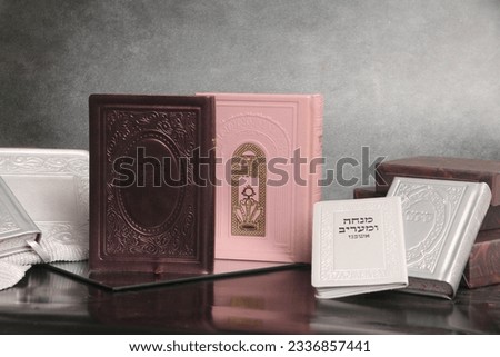jewish Prayer book. On the book it says: "Sidur Hashem" in Hebrew. On the pink book it is written: "Open the gates of heaven to our prayers" Royalty-Free Stock Photo #2336857441