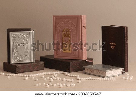 jewish Prayer books. On the pink book it is written: "Open the gates of heaven to our prayers", on the other books is written "Siddur" Royalty-Free Stock Photo #2336858747