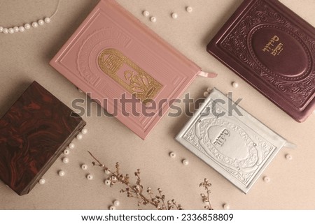 jewish Prayer books. On the pink book it is written: "Open the gates of heaven to our prayers", on the other books is written "Siddur"
