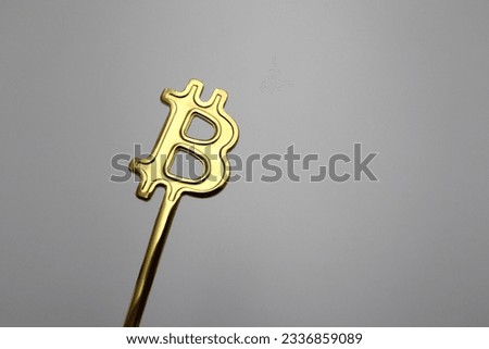 Golden Bitcoin crypto currency spoon stick sign logo chip icon creative and long term investment ratings capital financial planning and growing symbol on the trading market background