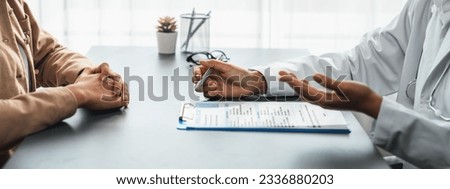 Doctor show medical diagnosis report and providing compassionate healthcare consultation to young patient in doctor clinic office. Doctor appointment and medical consult concept. Neoteric Royalty-Free Stock Photo #2336880203