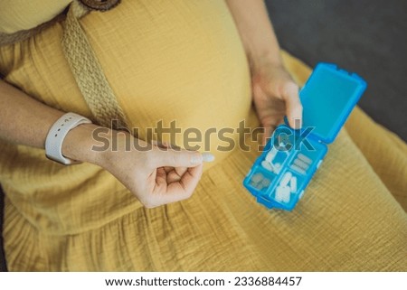 Prenatal Vitamins. Portrait Of Beautiful Smiling Pregnant Woman Holding Pill Box, Taking Supplements For Healthy Pregnancy While Sitting On Couch At Home, Free Space Royalty-Free Stock Photo #2336884457