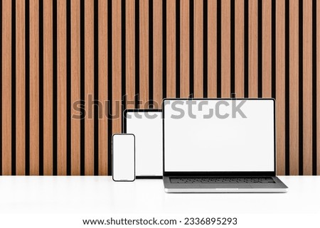 Phone, Tablet and Notebook against wood slat wall