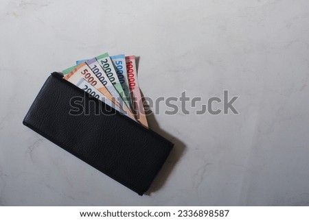 selective focus of money in a wallet against white background