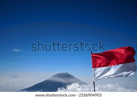 Indonesian flag waving by the wind with a beautiful background of nature