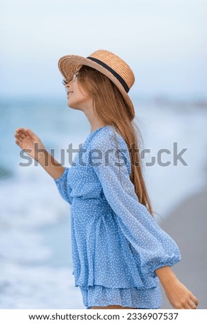Beautiful little girl in dress at beach having fun. Happy girl enjoy summer vacation background the blue sky and turquoise water in the sea on caribbean island