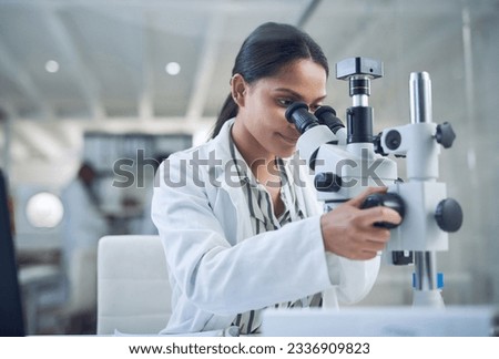 Science, microscope and innovation with a woman in a laboratory for medical research or experiment. Healthcare, medicine and a young indian engineer working in a lab for pharmaceutical development Royalty-Free Stock Photo #2336909823