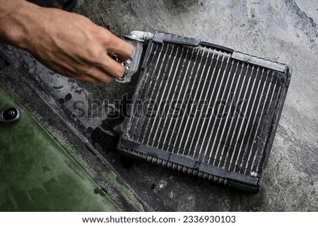 Close-up of car air conditioning evaporator coil leaks. Car air conditioning evaporator coils repair and service. Royalty-Free Stock Photo #2336930103