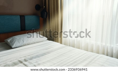 A room with a white bed with pillows, brightly lit by the morning sun.
Very comfortable and warm, very pleasant journey