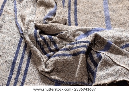 Grubby gray old blanket untidy on the floor Royalty-Free Stock Photo #2336941687