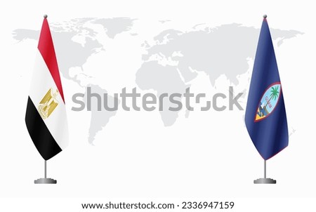 Egypt and Guam flags for official meeting against background of world map.