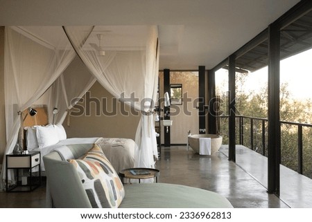 The luxury in the wilderness in a safari lodge hotel room, with spacious interior and breathtaking open views of Kruger Park.  Royalty-Free Stock Photo #2336962813