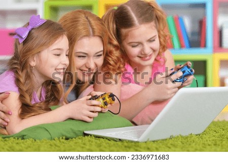 woman and girls using laptop. High quality photo