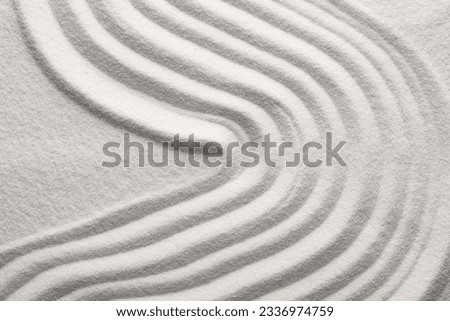 Pattern drawn on white sand, above view. Zen garden