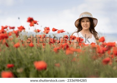 A nine-year-old girl in a poppy field