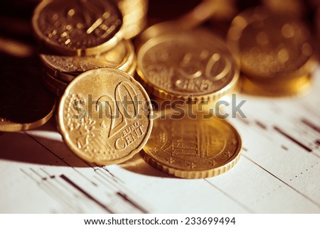 Euro coin on stock chart. Selective focus. Macro image.