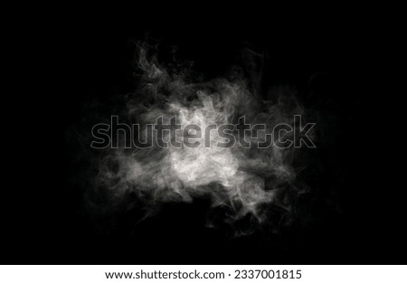 Close-up of steam or abstract white smog rising above. water droplets that can be seen that swirl beautifully from humidifier spray. Isolated on a black background Royalty-Free Stock Photo #2337001815