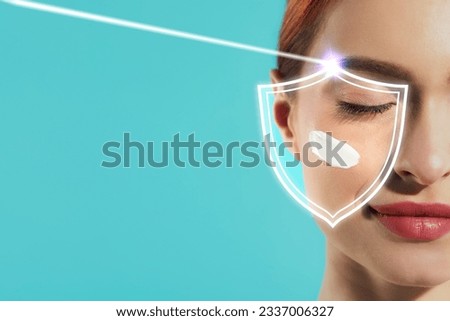 Sun protection care. Beautiful woman with sunscreen on face against turquoise background, space for text. Illustration of shield and ray Royalty-Free Stock Photo #2337006327