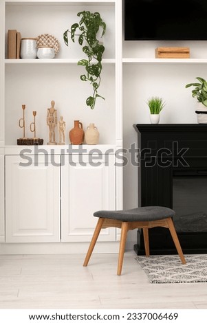 Stylish room interior with beautiful decor on shelves