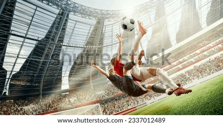Tense game moment. Dynamic image of two women, football players in motion, hitting ball in jump during match on 3D open air stadium. Concept of professional sport, competition, dynamics, game, ad