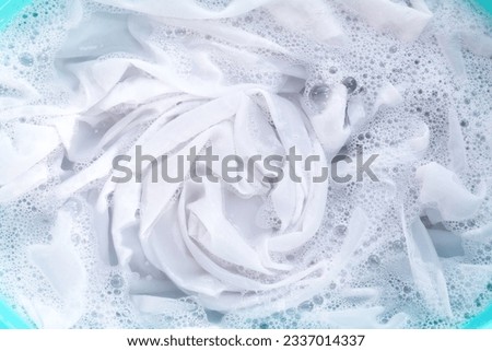 Soak a cloth before washing, white cloth Royalty-Free Stock Photo #2337014337