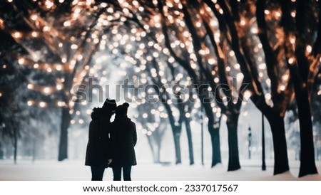 Silhouette of two lovers leaning towards each other in an atmospheric winter park with Christmas lights on the trees in the evening. Blurred defocused christmas image.