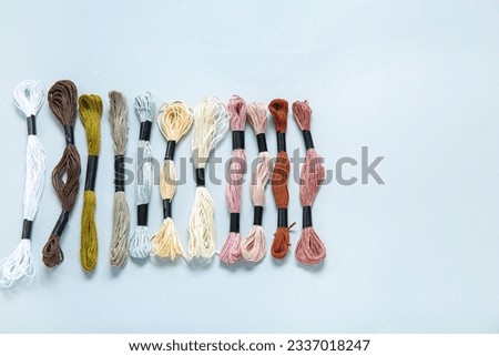 Different colorful mouline threads on white background