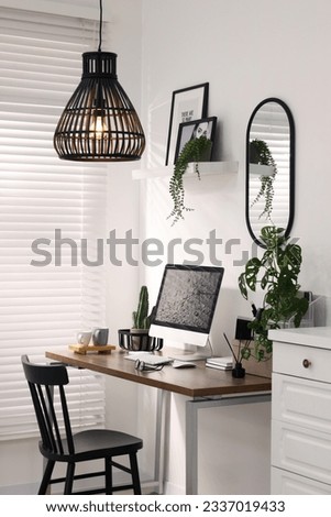 Cozy workspace with computer on wooden desk at home