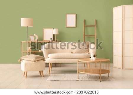 Interior of living room with cozy sofa, pouf and coffee table Royalty-Free Stock Photo #2337022015