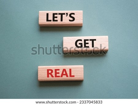 Lets get real symbol. Concept words Lets get real on wooden blocks. Beautiful grey green background. Business and Lets get real concept. Copy space. Conceptual word
