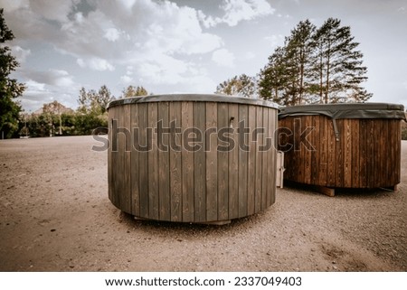Wooden hot tub is filled with water on outdoor
