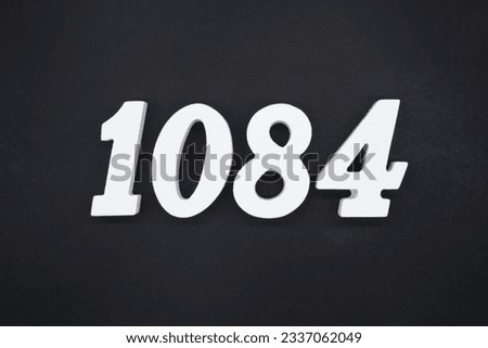 Black for the background. The number 1084 is made of white painted wood.
