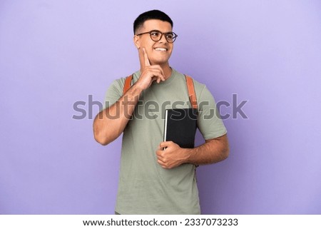 Handsome student man over isolated background thinking an idea while looking up