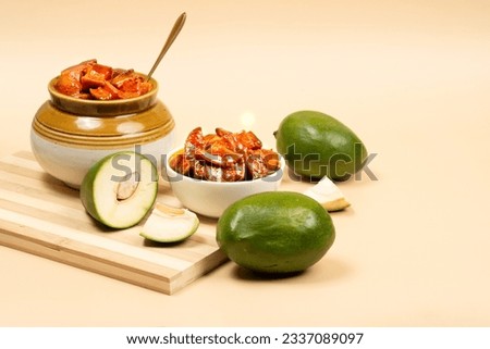 Andhra traditional home made raw mango sweet and spicy  pickle on a clean light brown  background- Selective focus
 Royalty-Free Stock Photo #2337089097