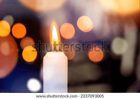 Ð¡andle burn on dark background with  blurry lights Royalty-Free Stock Photo #2337093005