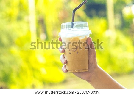 Refreshing iced coffee in nature - Relax and indulge in the moment.