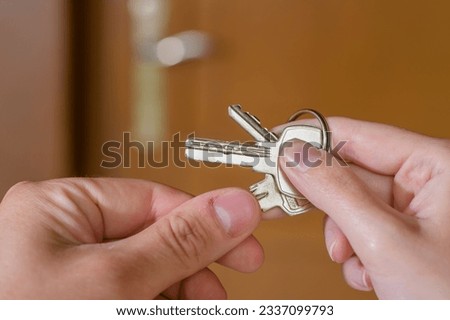 A bunch of keys to the house, apartment passed from hand to hand Royalty-Free Stock Photo #2337099793