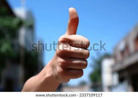 Human hand showing thumbs up