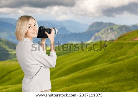 Woman photographer taking photo of beautiful mountains
