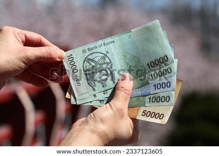 South Korean won. Currency of South Korea - hand holding used banknotes. Korean money. Royalty-Free Stock Photo #2337123605